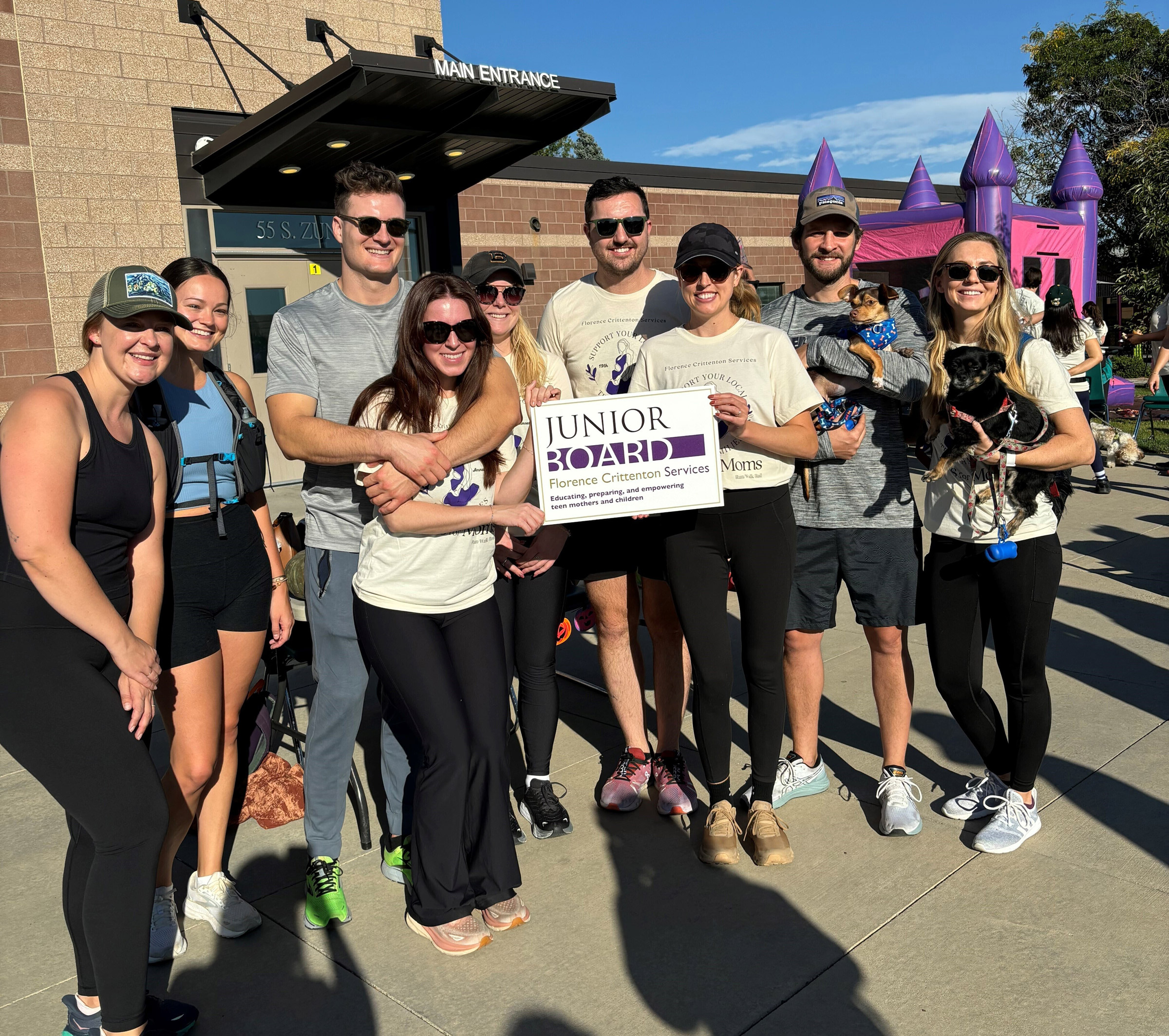 Group of people pose for picture at an event.