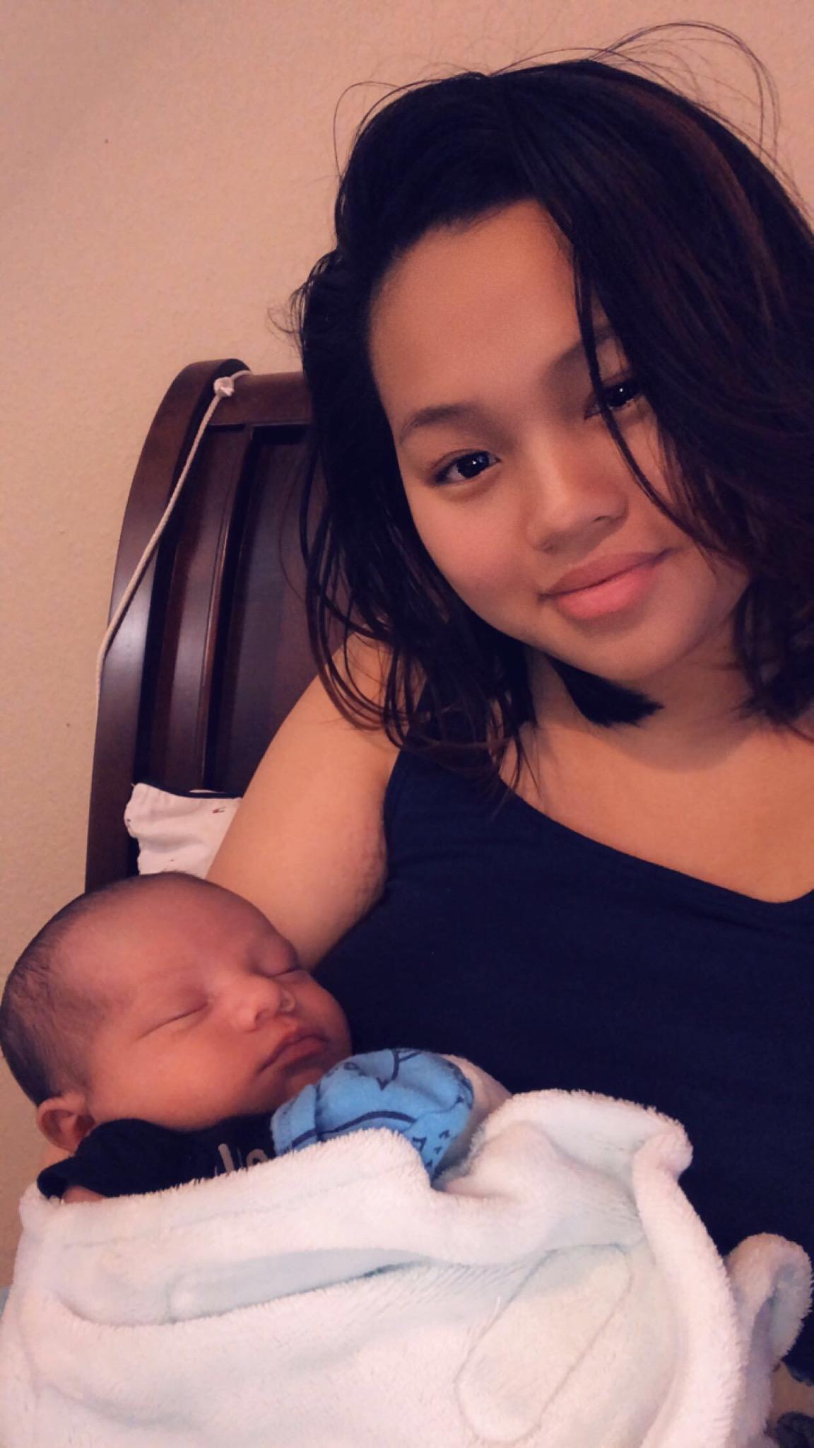 Mother holding sleeping baby in her arms