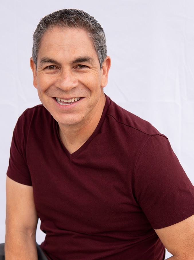 Smiling man in a red shirt.