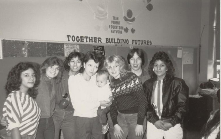 Group of women and child at education center.