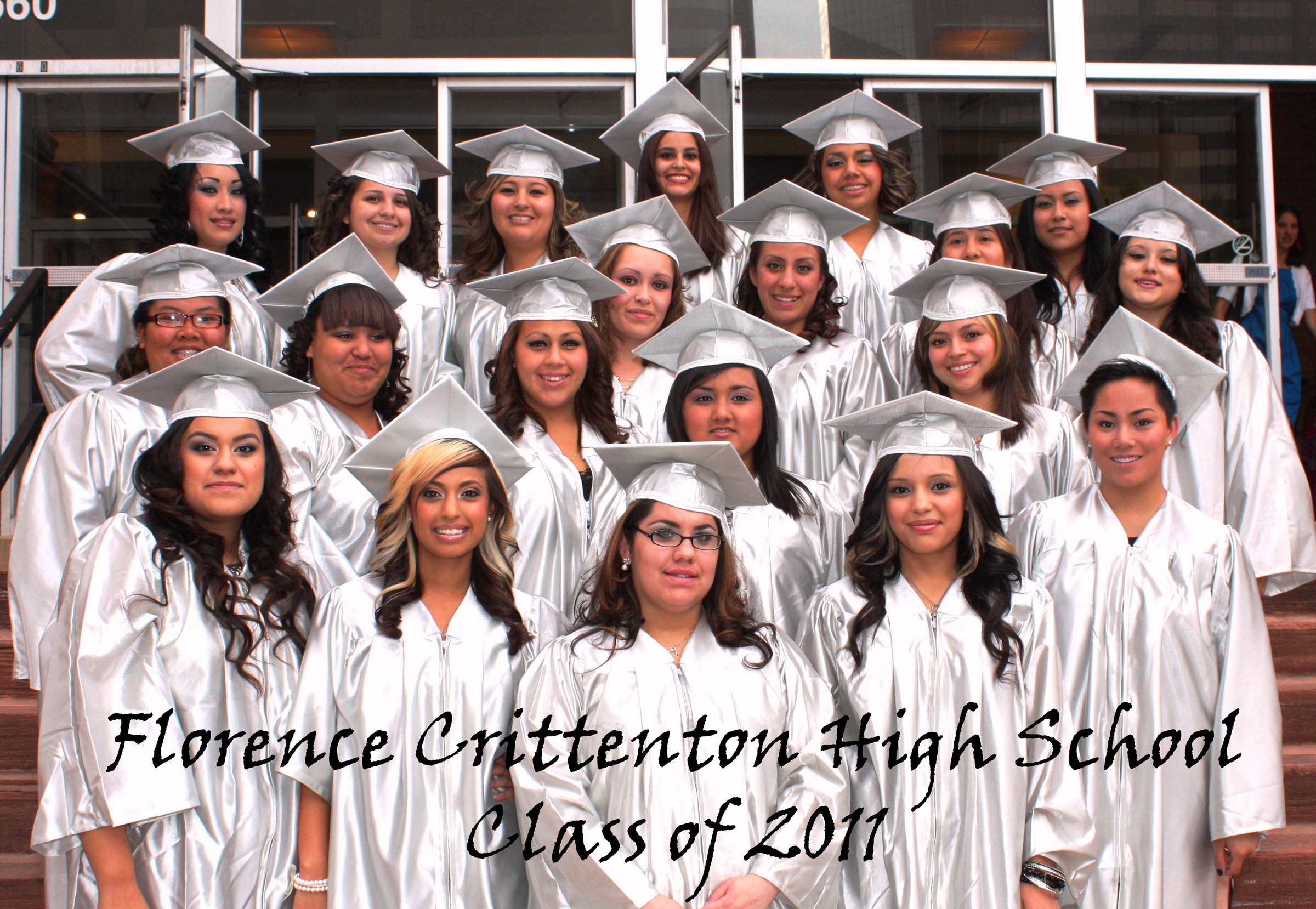 Graduates in silver gowns pose together, Class of 2011.