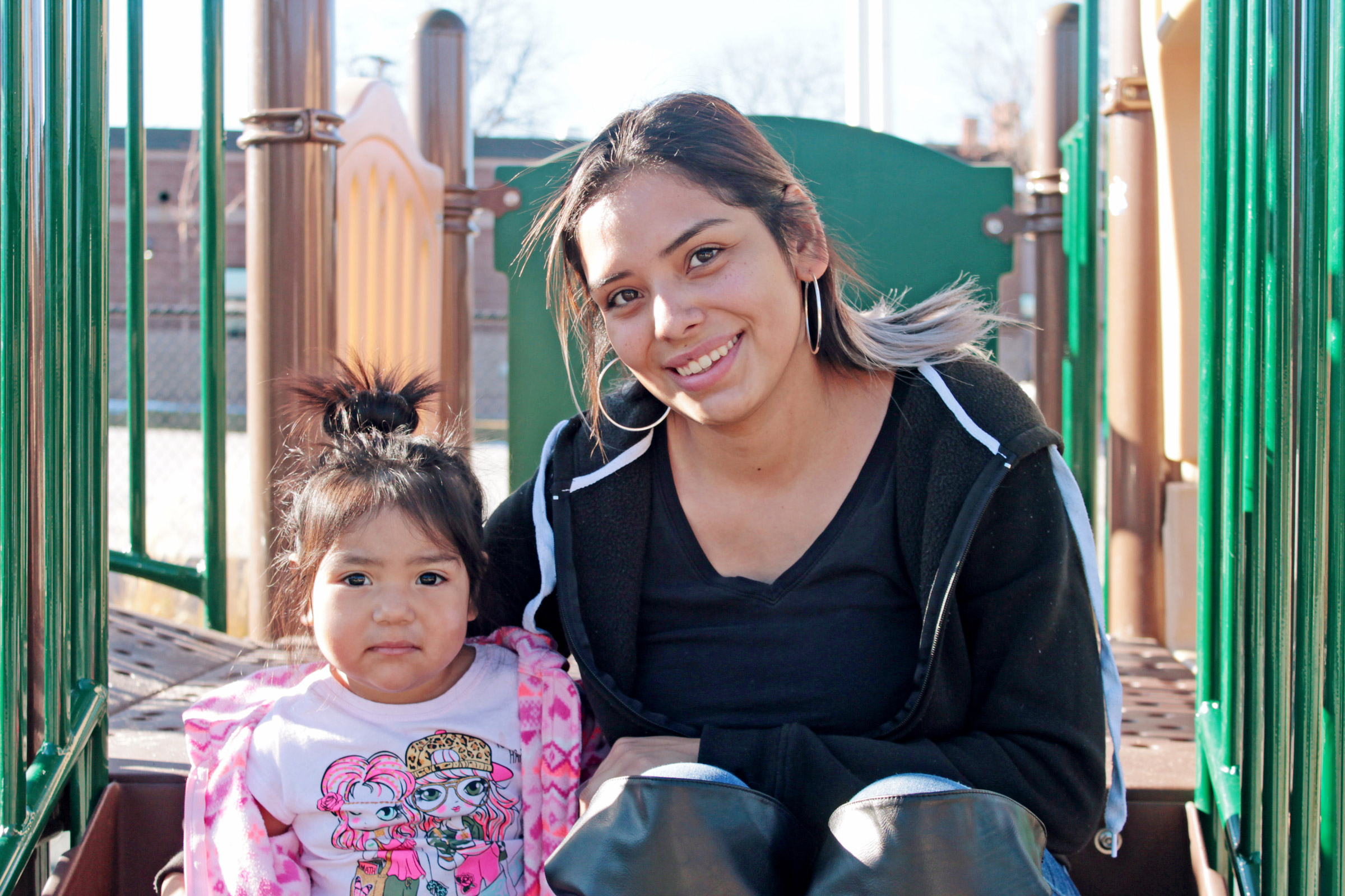 Mother and child smiling at playground