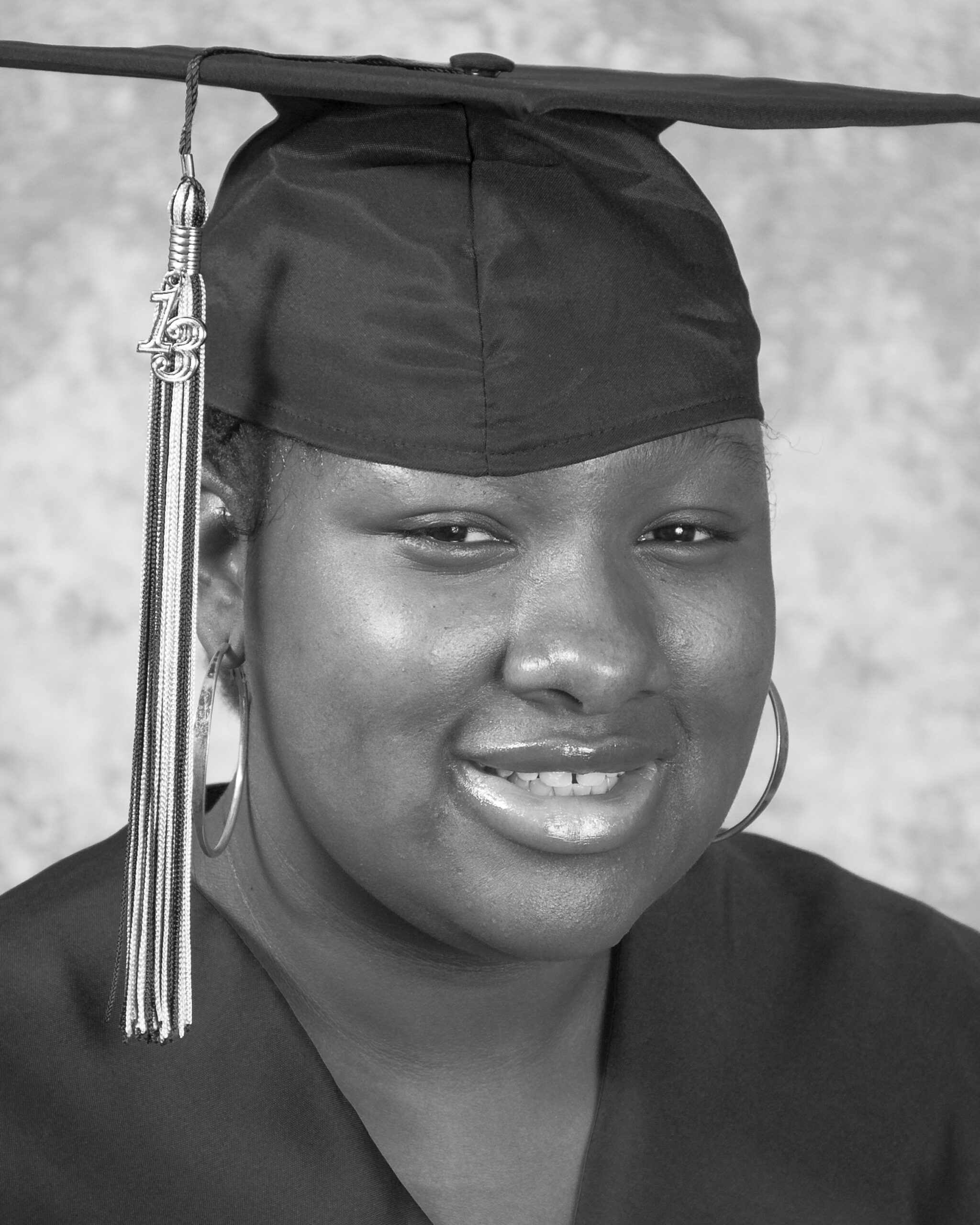 Smiling graduate wearing cap and gown