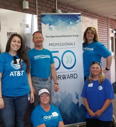 Smiling team by Professionals 50 Forward sign